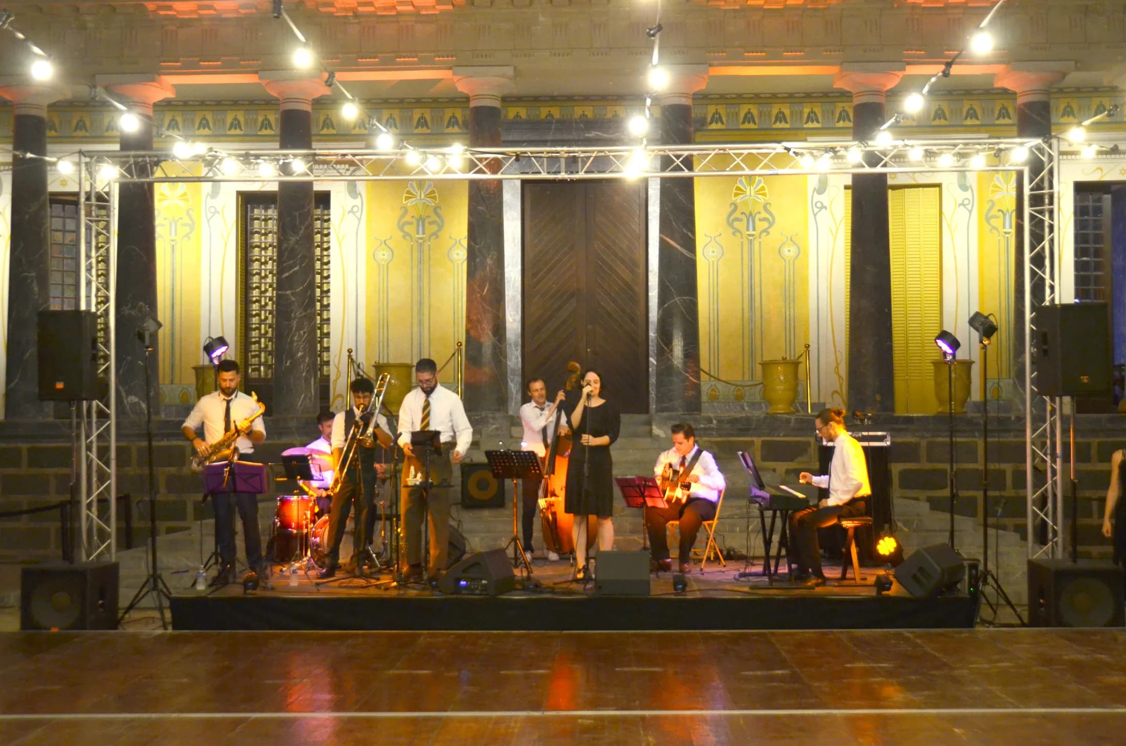 L’orchestre au complet sur scène, devant les colonnes et les décors peints du Château Laurens.